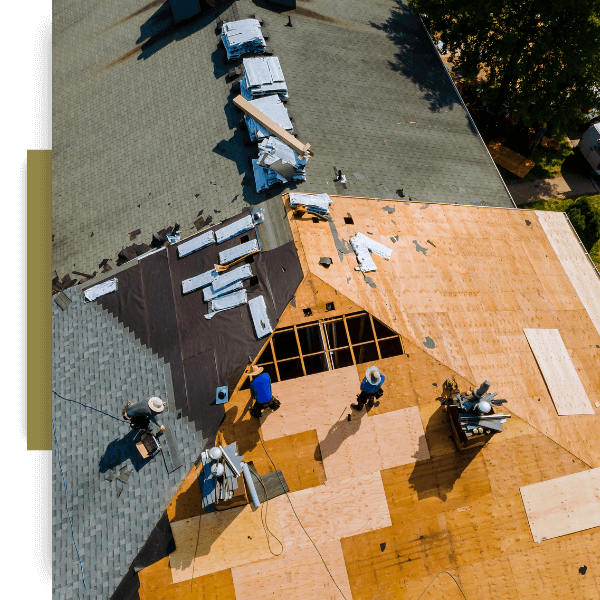 an aerial view of workers on a roof repairing
